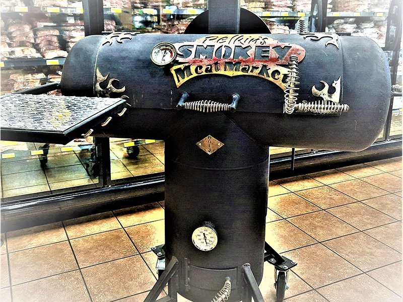 Gun Metal Woodfired Grille w/ red & yellow artwork saying Pelkin's Meat Market