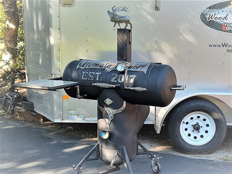 T-shaped black grill with silver artwork saying Ultimate Flavor Est. 2017