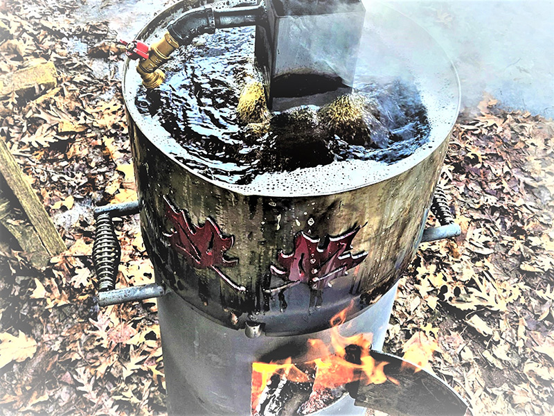 T-shaped black grill with red & gold-tone circle with Kerr artwork above and deer head with antlers below