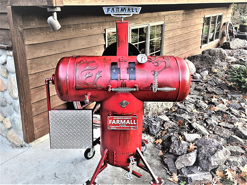 Red T-shaped grill with flame artwork and Farmall logo
