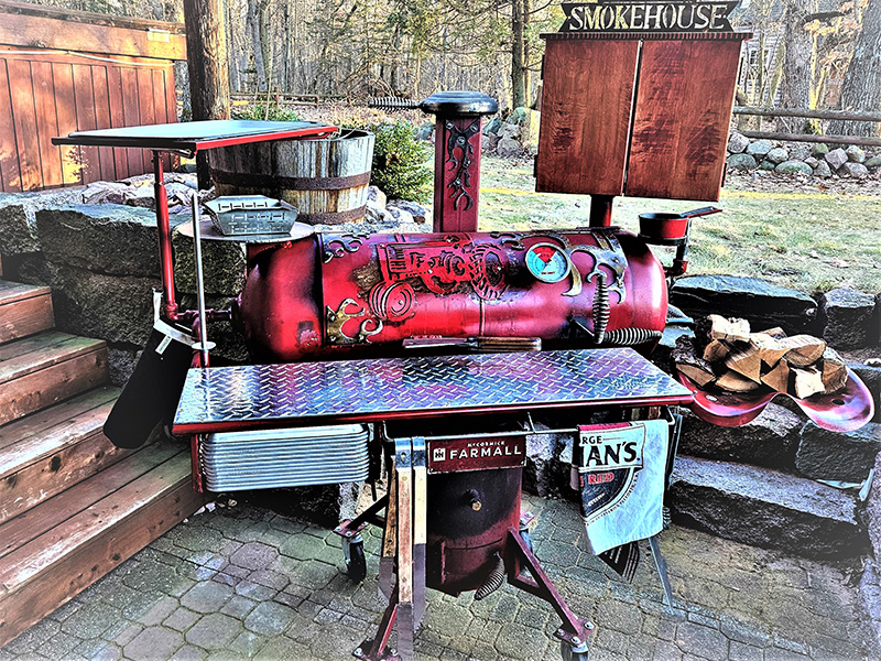 Red T-shaped grill with large diamond pattern shelf in front. Artwork of tractor