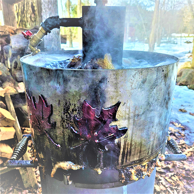 bullet maple syrup evaporator with red maple leaf artwork