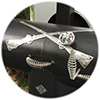 Close-up black grill cover artwork 2 silver metal muskets crossed.