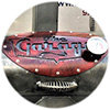 Close-up of grill cover with red artowrk saying The Garage written on it.