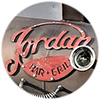 Close-up of grill cover with red artwork saying Jordan Bar & Grill on it