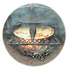 Close-up of pizza baking on a baking stone placed over hot coals in a WoodFiredGrille